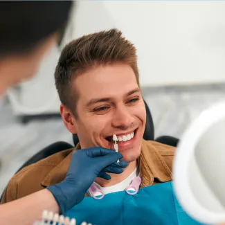 Patient comparing veneers to natural teeth